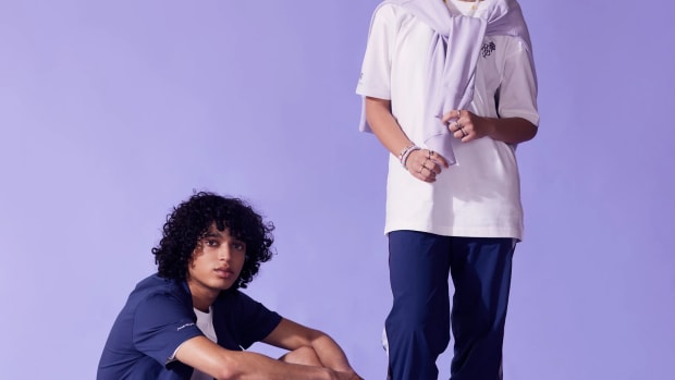 Models wearing blue and purple New Balance apparel.